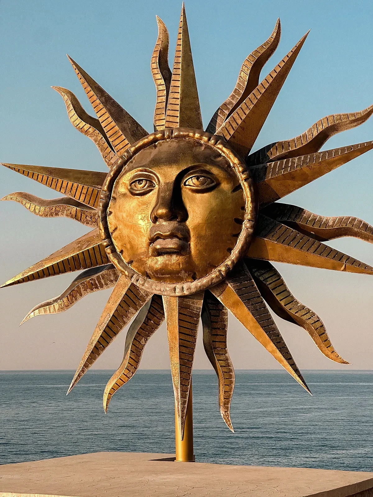 Close detail of Hydra brass sun sculpture