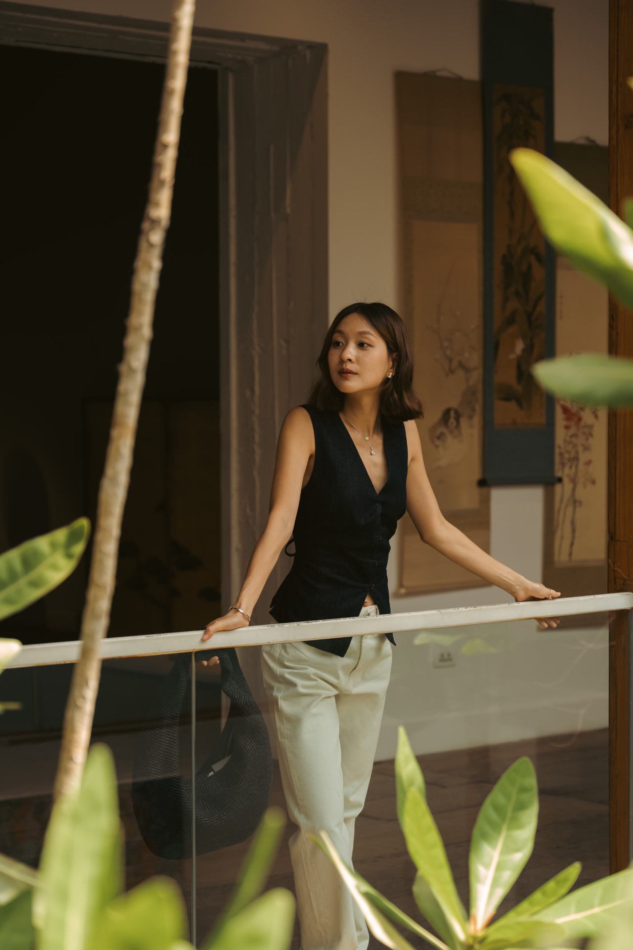 Woman in refined Solera jewelry on a sunlit balcony